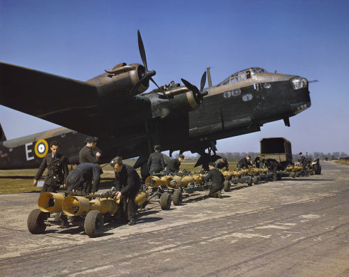Royal Air Force armourers check over the sixteen 250lb bombs before they are loaded into Short Stirling bomber N6101